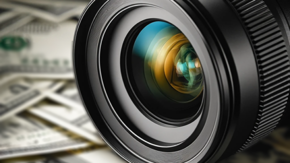 Camera lens on a bed of money
